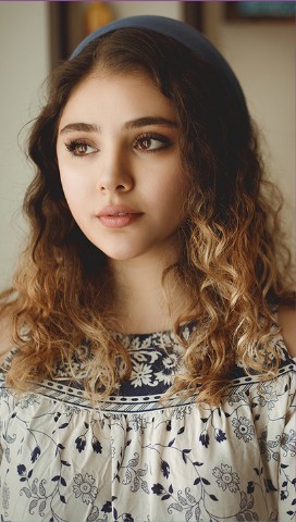Portrait of a young woman by a window